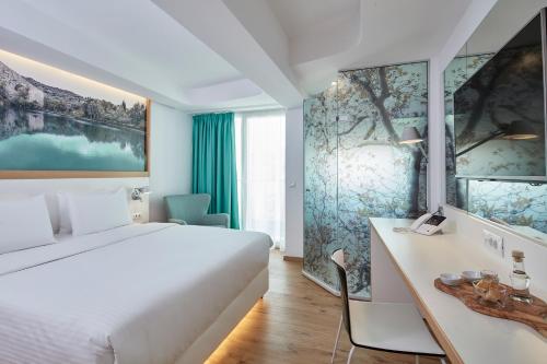 Giường trong phòng chung tại Olive Green Hotel