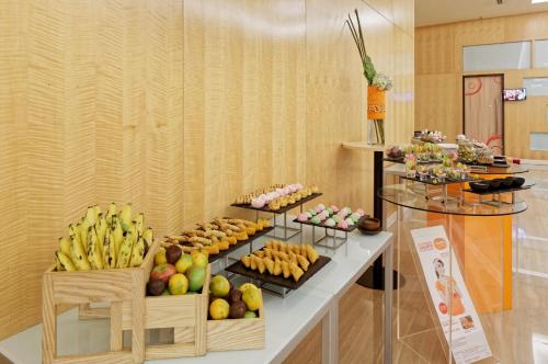 a buffet of fruits and vegetables on a table at HARRIS Hotel and Conventions Kelapa Gading Jakarta in Jakarta