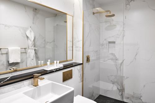 a bathroom with a sink and a mirror at Crowne Plaza Sydney Burwood by IHG in Sydney