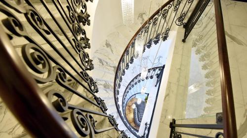 a spiral staircase with a mirror in a building at Hotel Ziya in Podgorica