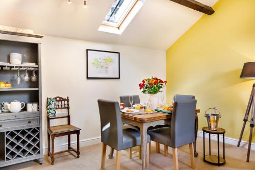 a dining room with a table and chairs at The Old Sweet Factory in Harrogate