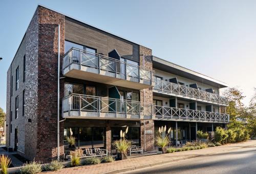 un edificio in mattoni con balcone sul lato di Just Eleven a Sankt Peter-Ording