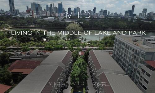 a sign that reads living in the middle of lake and park at MIQ Asoke808 Villa - Asoke BTS - garden pool - 16 Pax in Bangkok