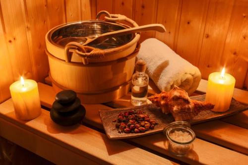 a table with candles and a plate of food and a tub at Archontiko Hatzipanayioti in Leonidion