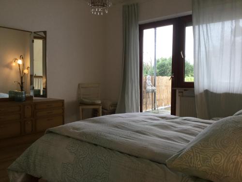 a bedroom with a bed and a window and a dresser at Beletage in Neuwied