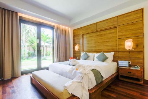 djabu Canggu Beach Villa में एक कमरे में एक या कई बेड