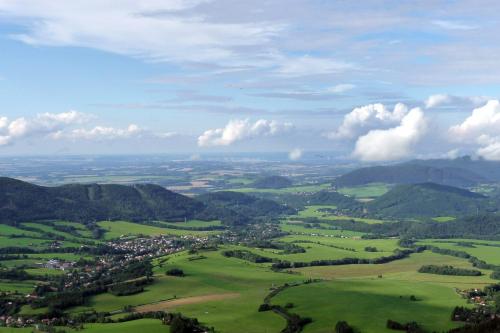 an aerial view of a green valley with mountains at Vila Encore in Valašské Meziříčí