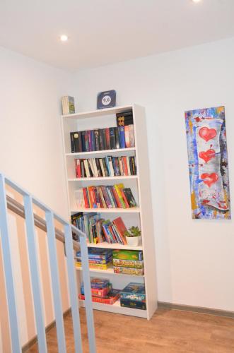 a book shelf filled with books next to a staircase at LaVaTe in Kappel-Grafenhausen