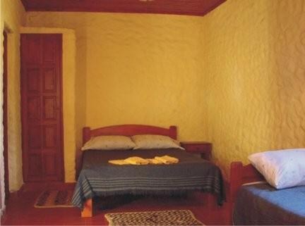 A bed or beds in a room at Cabañas Achalay