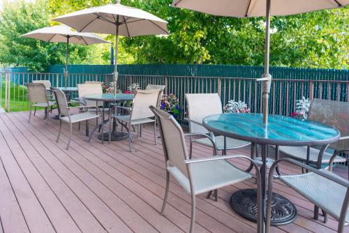 une terrasse avec des tables, des chaises et des parasols dans l'établissement Holiday Inn Express Spokane-Valley, an IHG Hotel, à Spokane Valley