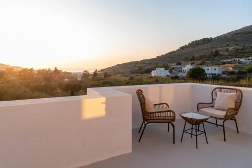 a patio with chairs and a table on a balcony at PAROS ELITAS VILLAS in Parikia