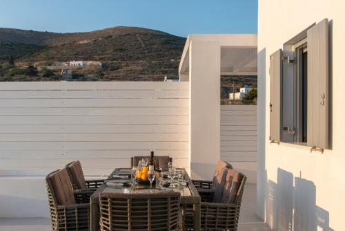 a table and chairs on a balcony with a view at PAROS ELITAS VILLAS in Parikia