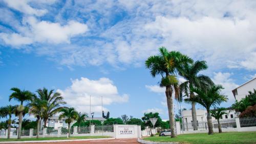 a group of palm trees next to a fence at Premier Hotel The Richards in Richards Bay