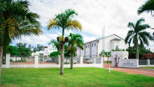 a group of palm trees in front of a building at Premier Hotel The Richards in Richards Bay