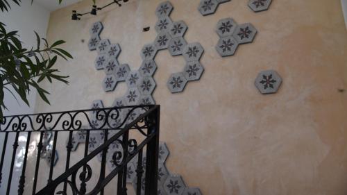 a staircase with blue and white tiles on the wall at Hotel Zamna Boutique in Mérida