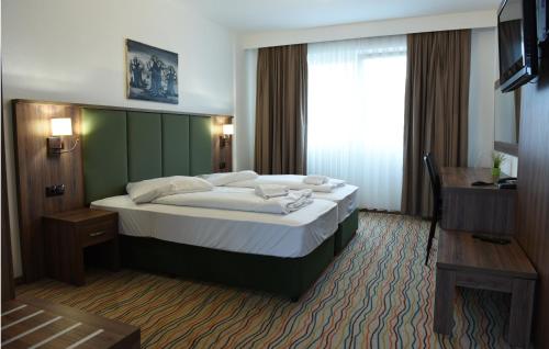 Tempat tidur dalam kamar di Hotel Olive Inn