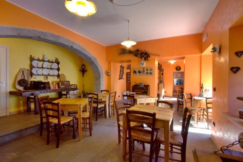 a restaurant with tables and chairs in a room at Albergo Alle Alpi in Comeglians