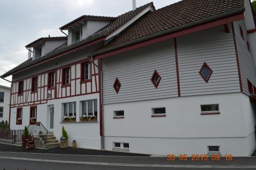 a white building with a red and white at BnB zum Schlüssel in Unterehrendingen