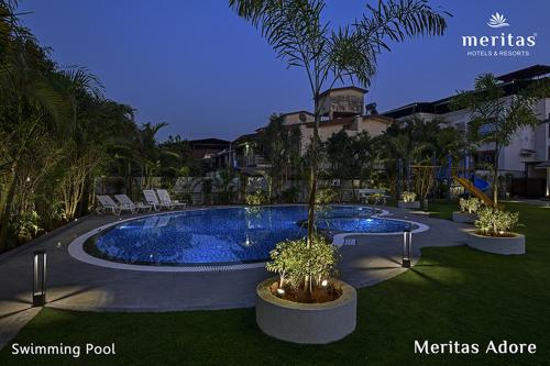 a swimming pool in the middle of a resort at Meritas Adore Resort in Lonavala