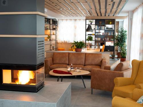 a living room with a couch and a fireplace at Red Fox Lodge in Breuil-Cervinia