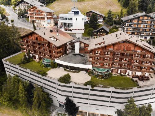 einen Blick über ein großes Gebäude mit einem Hof in der Unterkunft Hôtel Chalet Royal in Veysonnaz