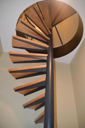 a stack of wooden sticks on a wall at Evelyns Corner Duplex in Ghent