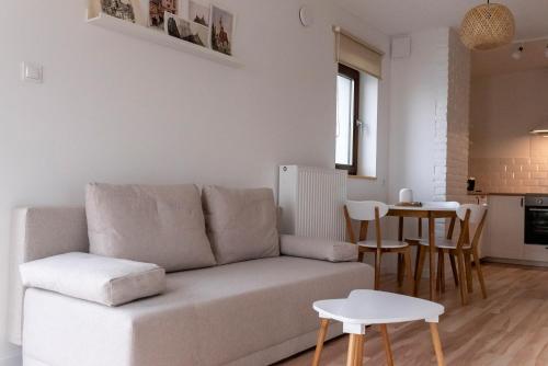 a living room with a couch and a table at Eco apartament Nałęczów in Nałęczów