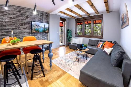 a living room with a couch and a table at Apartment ERAK HILL in Zlatibor