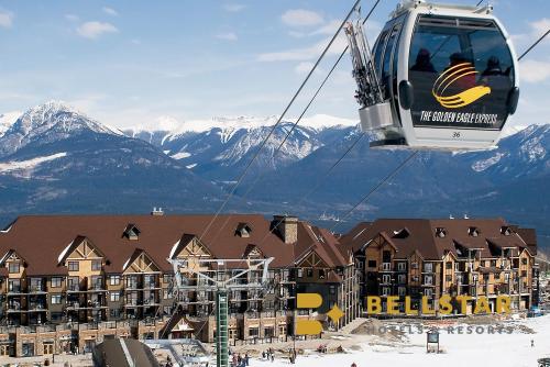 a ski resort with a ski lift in the mountains at Glacier Mountaineer Lodge in Golden