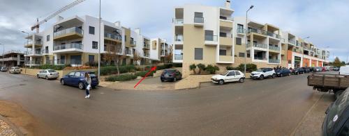 a street with cars parked in front of buildings at Albur Village B - Gerbera in Alvor