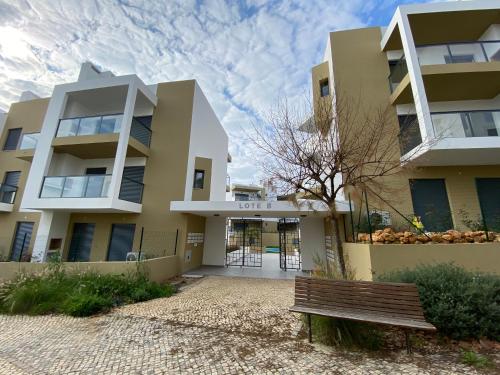 a building with a bench in front of it at Albur Village B - Gerbera in Alvor