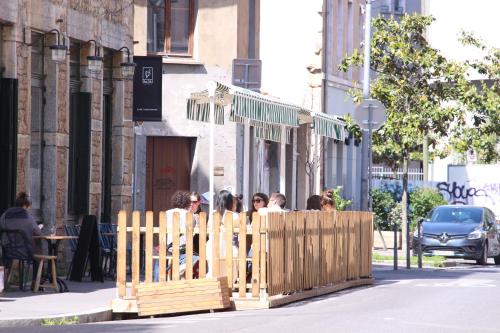 un grupo de personas de pie detrás de una valla de madera en HO36 Hostel, en Lyon