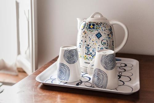 a vase and three candles on a tray at The Galileo Apartment in Pisa