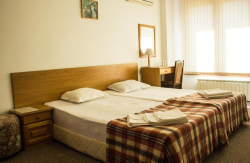 A bed or beds in a room at Family Hotel Saint Iliya