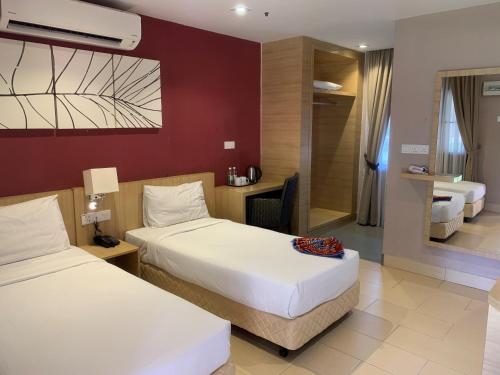 Tempat tidur dalam kamar di De Palma Resort Kuala Selangor