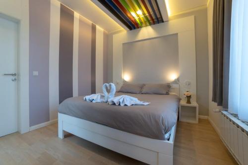 a bedroom with a bed with a towel on it at Apartments Slana Oaza in Tuzla