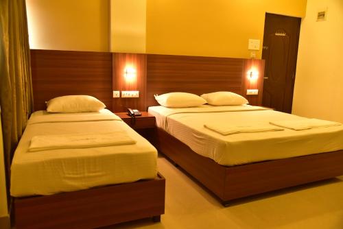 Tempat tidur dalam kamar di Hotel Citywalk Residency