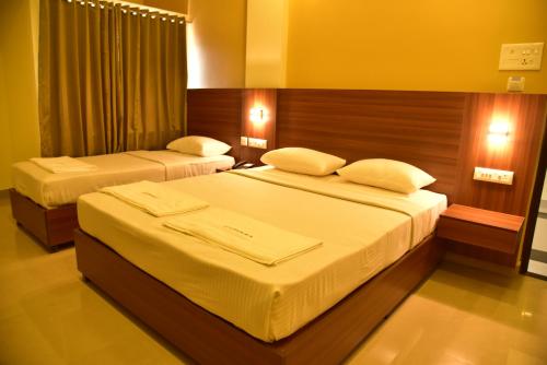 Tempat tidur dalam kamar di Hotel Citywalk Residency