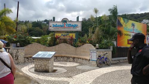 a group of people standing around a park with a sign at SandCastles Holiday #C9 in Ocho Rios