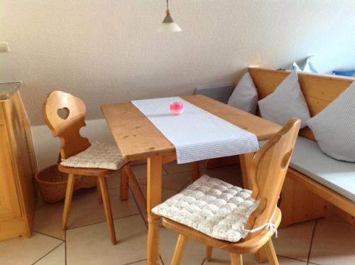 a wooden table and two chairs in a kitchen at Urseetalblick in Lenzkirch