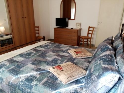 a bedroom with a bed with two pillows on it at L'Angolo Di San Pietro in Rome