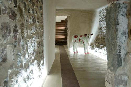 a cow standing in the hallway of a house at Stay COOPER l Goethe Guesthouse in Bolzano