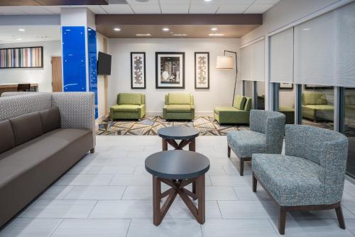 uma sala de espera num hospital com cadeiras e mesas em Holiday Inn Express & Suites- Sugar Land SE - Missouri City, an IHG Hotel em Missouri City