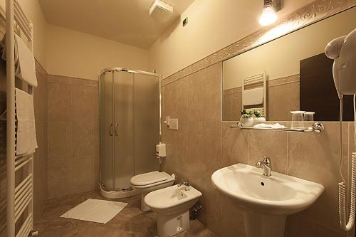 a bathroom with a sink and a toilet and a shower at Hotel Plestina Ristorante Pizzeria in Foligno