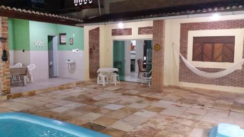 a room with a pool and a hammock in a room at LINDO SOBRADO COM PISCINA PARA ATÉ 10 HÓSPEDES! in Natal