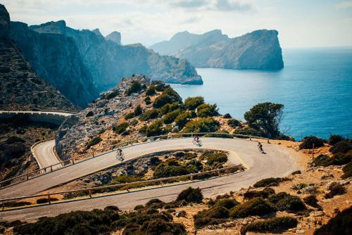 a winding road on a mountain next to the ocean at Hotel Paradiso Garden in Playa de Palma