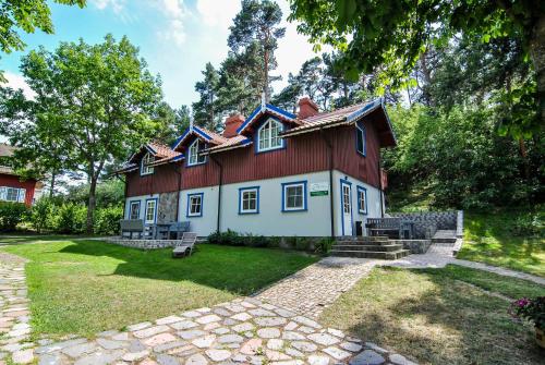 a house with a red roof at Apartamentai Geliu Vila in Nida