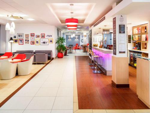 a lobby of a store with chairs and a bar at ibis Southampton in Southampton