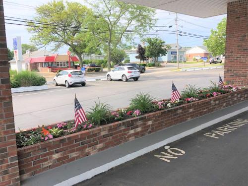 a brick retaining wall with american flags in a street at Falmouth Inn in Falmouth