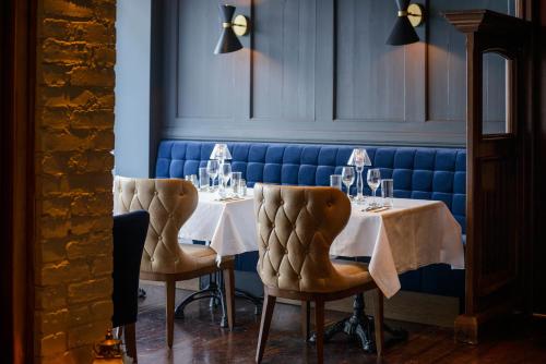 a dining room with two tables and two chairs at Kilkenny Hibernian Hotel in Kilkenny